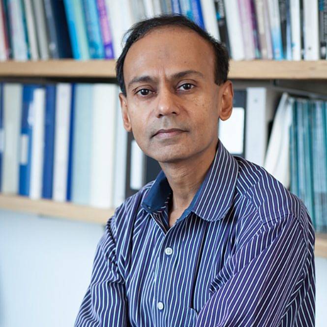 photo of Srini Devadas seated in his office