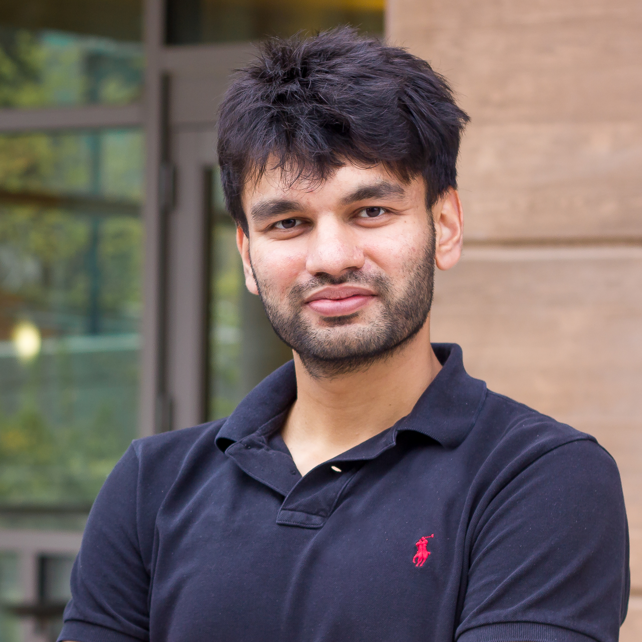 photo of Pulkit Agrawal in front of brown building