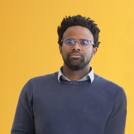 photo of Michael Carbin in front of yellow wall
