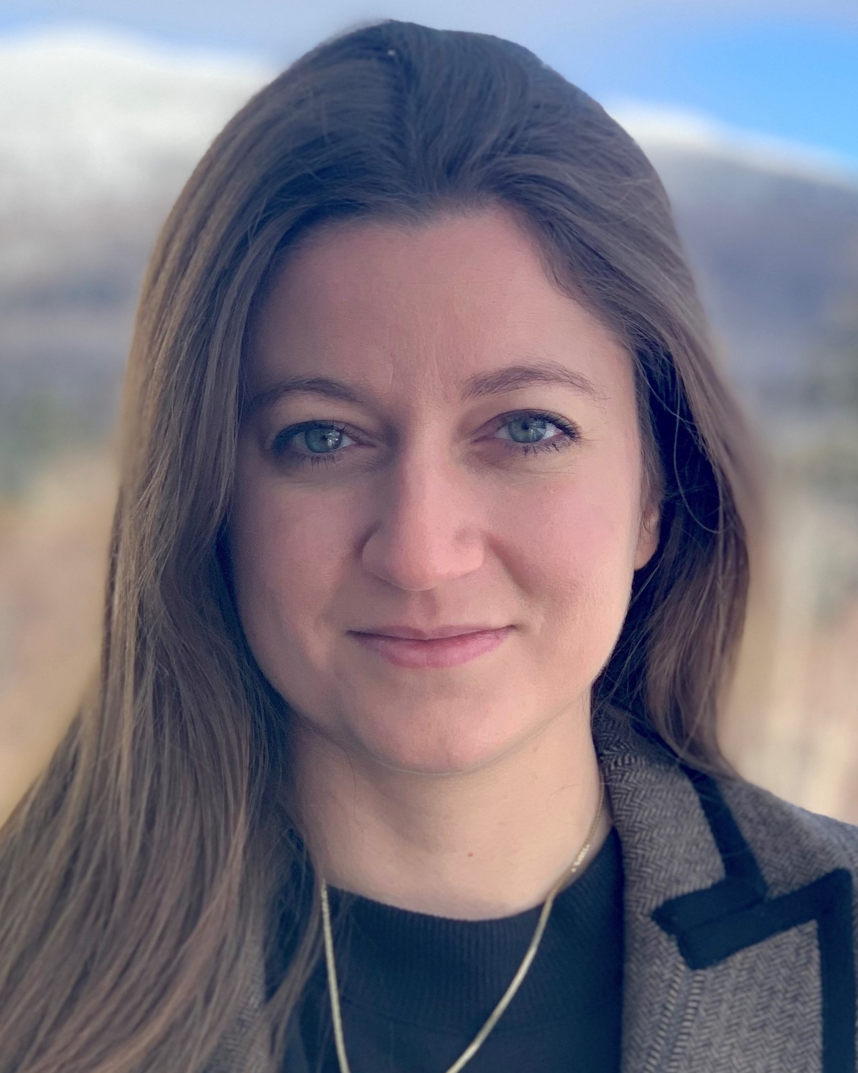 photo of Jelena Notaros in brown blazer in front of mountain view