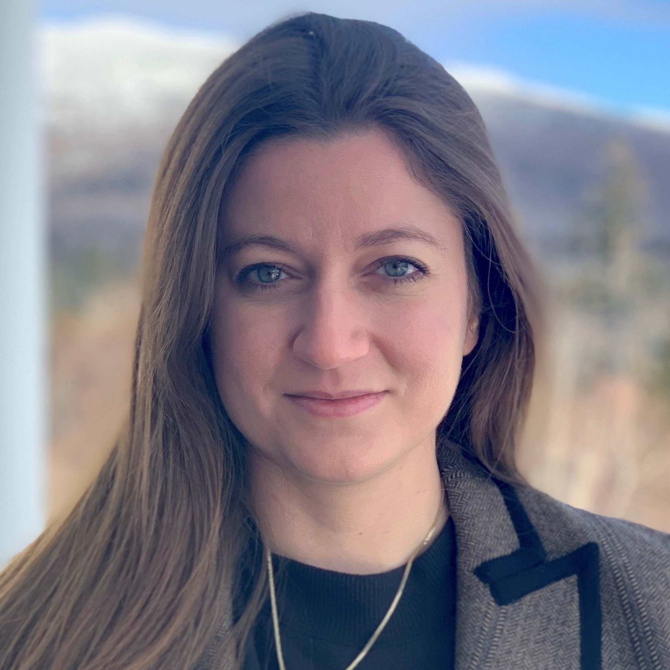 photo of Jelena Notaros in brown blazer in front of mountain view