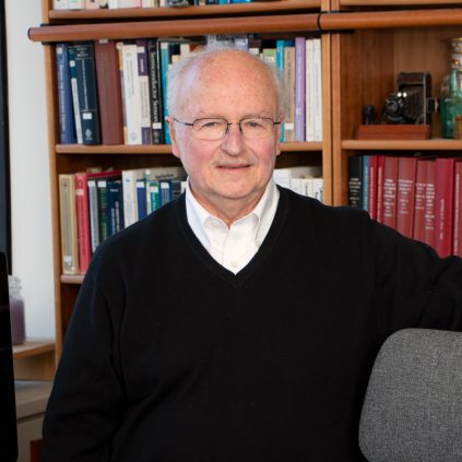 photo of Harry Tuller in his office in front of books