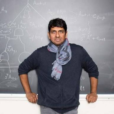 Vinod Vaikuntanathan standing in front of chalkboard (photo credit: scott bauer)