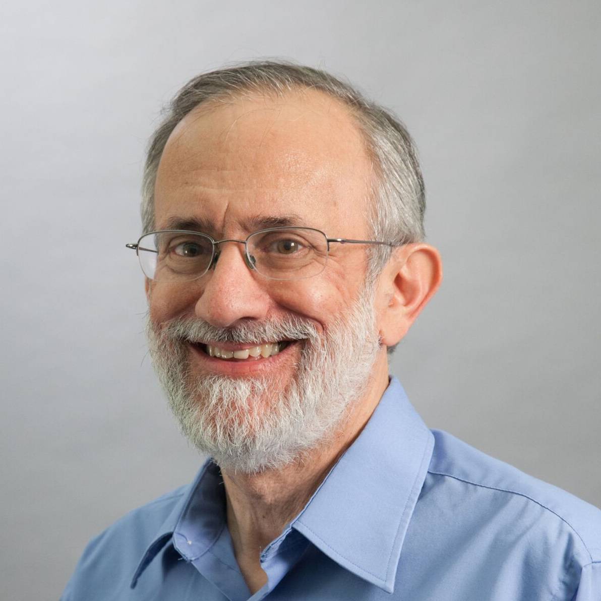 photo of Joel Emer with grey background