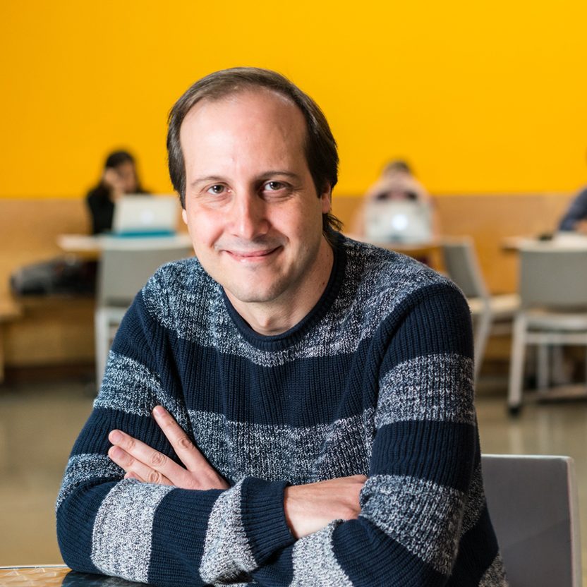 photo of antonio torralba seated in front of yellow wall