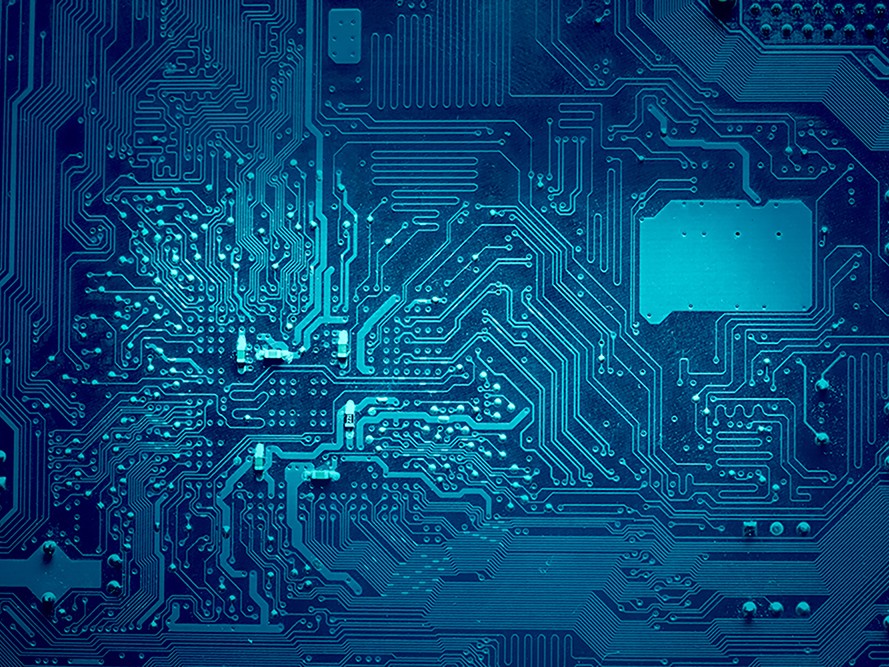 Blue color computer electronic circuits faded to dark blue at the sides.