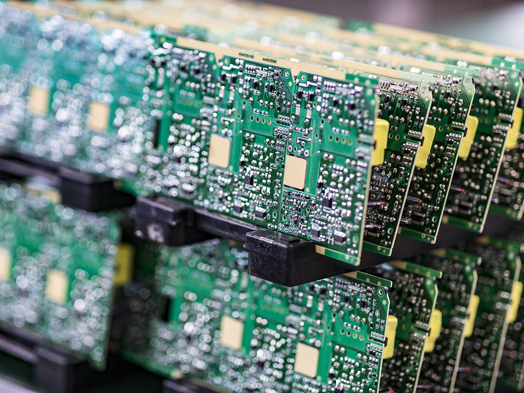 Blurred macro image of a row of green microchips.