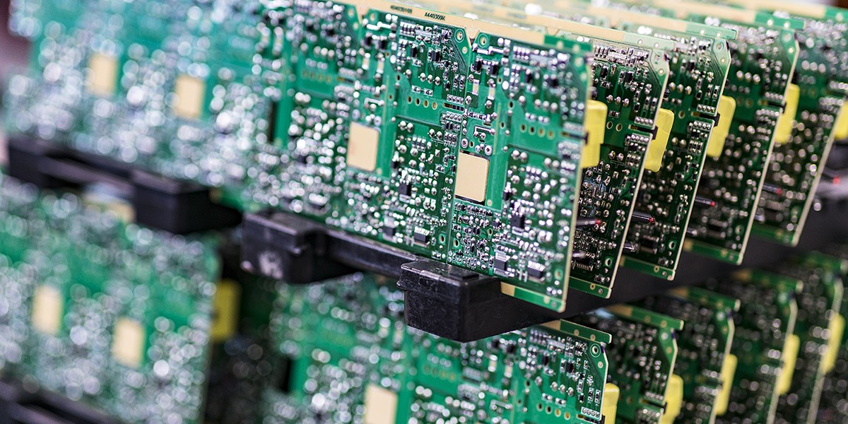 Blurred macro image of a row of green microchips.