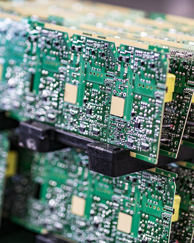 Blurred macro image of a row of green microchips.