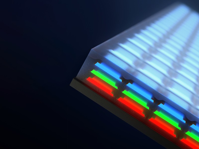 Closeup of a screen has 3 layers of individual LEDs; blue on top, then green and red.