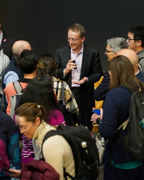 Pat Gelsinger smiles as he is surrounded by people eager to talk to him after the event.