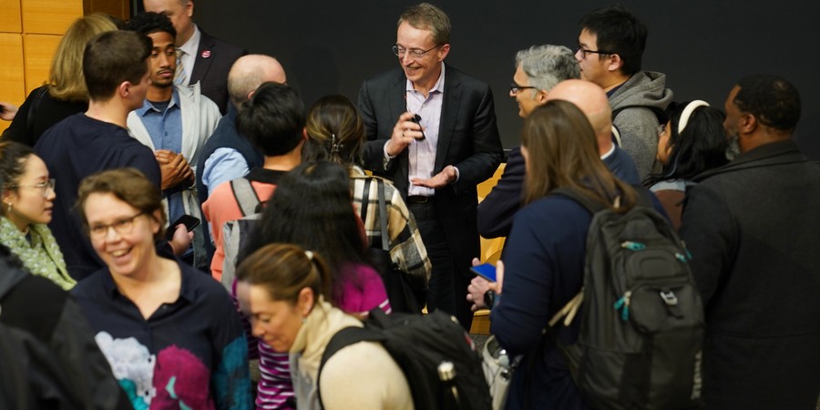 Pat Gelsinger smiles as he is surrounded by people eager to talk to him after the event.