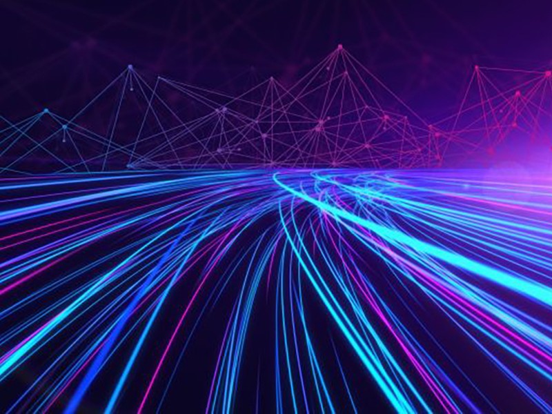 Graphic illustration showing blue and purple lines in the likeness of auto tail lights captured in a long exposure against a purple background. Mountains made of geometric triangle shapes appear in the background.