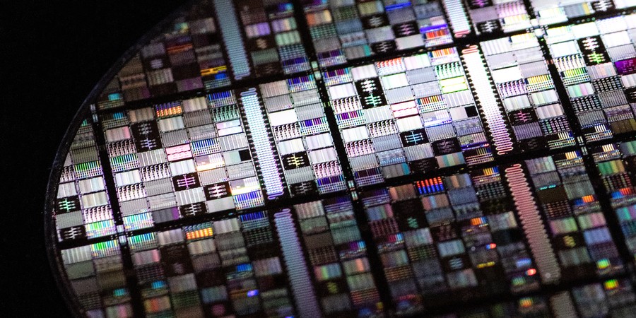 A close-up shot of a superconducting qubit wafer, showing microfabricated circuits