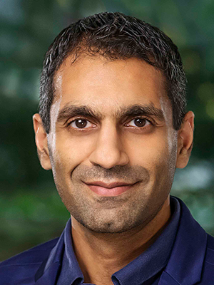 color photo headshot of Naveen Verma wearing a blue dress shirt and blue suit jacket