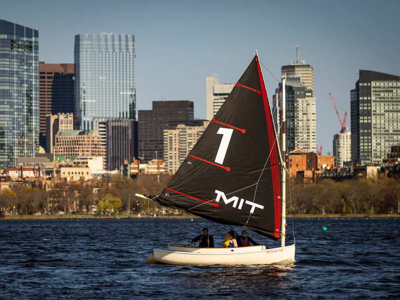 An MIT Sailboat bearing the number 1 on its sail on the Charles River