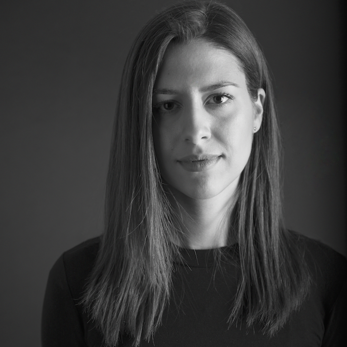 woman wearing black shirt in front of grey background